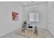 Minimalist office with a glass-top desk, modern art and natural light; promoting a clean, productive workspace at 10752 Patina Hills Ct, Las Vegas, NV 89135