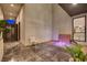 Relaxing outdoor lounge area with spa, waterfall feature, and sleek tile flooring at 10752 Patina Hills Ct, Las Vegas, NV 89135