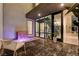 Stylish outdoor patio with water feature and interior view of modern staircase at 10752 Patina Hills Ct, Las Vegas, NV 89135