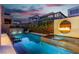 Backyard pool featuring integrated water and fire elements, surrounded by lush landscaping at 10752 Patina Hills Ct, Las Vegas, NV 89135