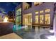A luxury pool featuring an integrated fire pit creates a cozy atmosphere for evening enjoyment at 10752 Patina Hills Ct, Las Vegas, NV 89135