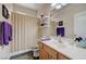 Functional bathroom features a vanity with sink, a shower with patterned curtain, and neutral tones at 1076 Crescent Falls St, Henderson, NV 89011