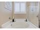 Bright bathroom with a soaking tub, separate shower, and plantation shutters, offering a luxurious bathing experience at 1076 Crescent Falls St, Henderson, NV 89011