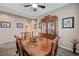 Traditional dining room featuring a wooden table with decorative centerpieces and display cabinet at 1076 Crescent Falls St, Henderson, NV 89011