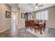 Traditional dining room with dark wood table, chairs, and hutch, complemented by neutral walls and light-filtering shutters at 1076 Crescent Falls St, Henderson, NV 89011