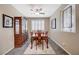 Dining room features a dark wood table with seating for four, a decorative hutch, and a window with shutters at 1076 Crescent Falls St, Henderson, NV 89011