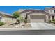 Charming single-story home with a well-maintained front yard and a two-car garage at 1076 Crescent Falls St, Henderson, NV 89011