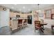 Kitchen with breakfast bar seating, adjacent to dining area and featuring stainless steel appliances at 1076 Crescent Falls St, Henderson, NV 89011