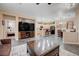Open-concept living area with tiled flooring, access to the kitchen, and bedroom doorway at 1076 Crescent Falls St, Henderson, NV 89011