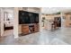 Bright and airy living space features tile floors, open to the kitchen, and modern lighting at 1076 Crescent Falls St, Henderson, NV 89011