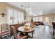 Spacious living room with dining area, featuring plantation shutters and ample natural light at 1076 Crescent Falls St, Henderson, NV 89011