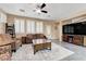 Inviting living room featuring neutral color palette, tiled floors, and shuttered windows at 1076 Crescent Falls St, Henderson, NV 89011