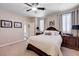 Bright main bedroom featuring a well-made bed, side tables, and a window with shutters, creating a relaxing space at 1076 Crescent Falls St, Henderson, NV 89011