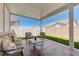 Relaxing covered patio with plush seating and artificial turf at 1076 Crescent Falls St, Henderson, NV 89011