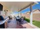 The covered patio includes a barbecue, dining table with seating and outdoor furniture at 1076 Crescent Falls St, Henderson, NV 89011
