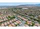 An aerial shot shows the neighborhood layout and its many red tiled roofs at 11253 Revelry Ln, Las Vegas, NV 89138