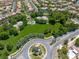 Overhead shot of a well-maintained neighborhood park with playgrounds, green spaces, and a decorative roundabout at 11253 Revelry Ln, Las Vegas, NV 89138