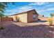 A simple backyard has a concrete patio and rock ground cover surrounding the house at 11253 Revelry Ln, Las Vegas, NV 89138