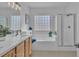 Bright bathroom with dual sinks, a soaking tub, and a separate shower at 11253 Revelry Ln, Las Vegas, NV 89138