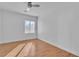This bright bedroom boasts a large window and wood-look floors at 11253 Revelry Ln, Las Vegas, NV 89138