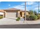 Charming single-story home with desert landscaping, tile roof, stone accents, and attached two-car garage at 11253 Revelry Ln, Las Vegas, NV 89138
