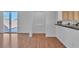 Bright living room features wood floors and sliding glass door to the backyard at 11253 Revelry Ln, Las Vegas, NV 89138