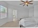Bright main bedroom with a ceiling fan, window, and door leading to the bathroom at 11253 Revelry Ln, Las Vegas, NV 89138