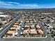 Expansive aerial view of a residential area featuring well-maintained homes, streets, and a distant mountain range at 1201 N Buffalo Dr # 202, Las Vegas, NV 89128