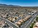 Overhead view of a well-planned community, showcasing neat homes, roads, and desert scenery at 1201 N Buffalo Dr # 202, Las Vegas, NV 89128