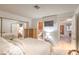 Bright bedroom with a bed, side tables, and a hallway leading to the bathroom and other rooms at 1201 N Buffalo Dr # 202, Las Vegas, NV 89128