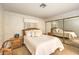 Serene bedroom featuring a plush bed, mirrored closet doors, and a tranquil ambiance for a restful night's sleep at 1201 N Buffalo Dr # 202, Las Vegas, NV 89128