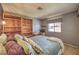 Comfortable bedroom featuring built-in bookshelves, a cozy bed, and natural light for a restful retreat at 1201 N Buffalo Dr # 202, Las Vegas, NV 89128