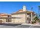 Condo building featuring stucco siding, carport parking, and well-maintained grounds at 1201 N Buffalo Dr # 202, Las Vegas, NV 89128