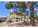 Inviting condo complex featuring well-maintained landscaping and convenient staircase access at 1201 N Buffalo Dr # 202, Las Vegas, NV 89128