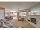 Open-concept living room showcases a fireplace, comfortable seating, and seamless flow to the kitchen and dining area at 1201 N Buffalo Dr # 202, Las Vegas, NV 89128