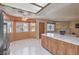 Open floor plan connecting kitchen and living room offering island seating and natural light at 1201 N Buffalo Dr # 202, Las Vegas, NV 89128