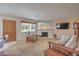 Cozy living room featuring a stone fireplace, comfortable seating, and ample natural light for a relaxing atmosphere at 1201 N Buffalo Dr # 202, Las Vegas, NV 89128