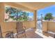Cozy outdoor patio with a view and metal chairs overlooking the complex and mature trees at 1201 N Buffalo Dr # 202, Las Vegas, NV 89128
