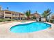 Community pool and hot tub with nearby condos and well-maintained landscaping on a sunny day at 1201 N Buffalo Dr # 202, Las Vegas, NV 89128