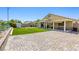 A well kept backyard with a lawn, covered patio, brick pavers and backyard shed is great for entertaining at 1208 Neva Ranch Ave, North Las Vegas, NV 89081