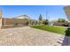 Manicured backyard featuring hardscape, artificial turf, desert landscaping, and a storage shed for added convenience at 1208 Neva Ranch Ave, North Las Vegas, NV 89081