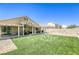 Green backyard features artificial turf, providing a low-maintenance and inviting outdoor space for relaxation and recreation at 1208 Neva Ranch Ave, North Las Vegas, NV 89081