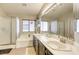 Bright bathroom featuring dual sinks, a soaking tub, and a separate glass-enclosed shower at 1208 Neva Ranch Ave, North Las Vegas, NV 89081