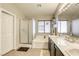 Bright bathroom featuring dual sinks, a soaking tub, and a separate glass-enclosed shower at 1208 Neva Ranch Ave, North Las Vegas, NV 89081