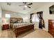 Bedroom features a ceiling fan, neutral walls, carpet, and window with black and gold curtains at 1208 Neva Ranch Ave, North Las Vegas, NV 89081