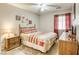 Comfortable bedroom featuring a ceiling fan, carpeted floors, and warm-toned curtains at 1208 Neva Ranch Ave, North Las Vegas, NV 89081