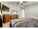 Bedroom features carpet, neutral walls, a ceiling fan, a dresser, and a dark wood bed frame at 1208 Neva Ranch Ave, North Las Vegas, NV 89081