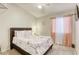Cozy bedroom with plush bedding, a ceiling fan, and light-filtering curtains for a relaxed ambiance at 1208 Neva Ranch Ave, North Las Vegas, NV 89081