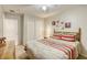 Comfortable bedroom featuring a ceiling fan, carpeted floors, and warm-toned curtains at 1208 Neva Ranch Ave, North Las Vegas, NV 89081