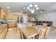 Open-concept kitchen and dining area with stainless steel appliances, granite counters, and a breakfast bar at 1208 Neva Ranch Ave, North Las Vegas, NV 89081